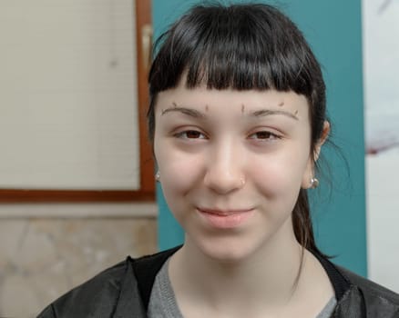 Permanent makeup. Verification of proportions. Cosmetologist applying permanent make up on eyebrows- eyebrow tattoo