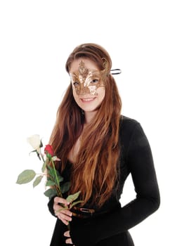 A close up image of a beautiful woman in a black dress and a gold.mask over her face holding roses in hand, isolated for white background.