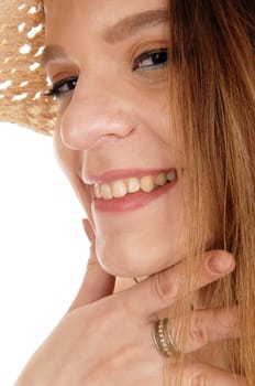 A young woman looking at the camera in a closeup image with one .hand at her chin, wearing a hat, isolated for white background.