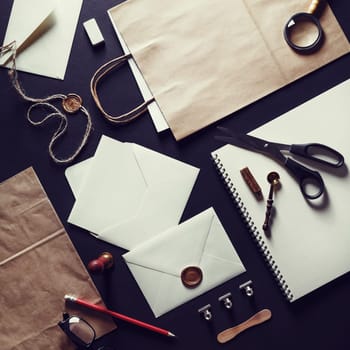 Blank stationery set on black paper background. Template for branding identity. Vintage toned image. Top view.