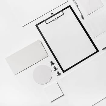 Blank stationery template on white paper background. Top view. Flat lay.
