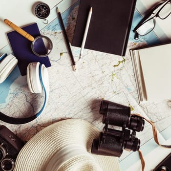 Tourism concept. Outfit of traveler on white paper background. Travel accessories and items. Vintage toned image. Top view. Flat lay.