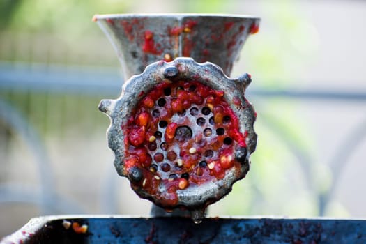 Hand-powered mincing machine used for grinding paprika. Meat or paprika grinder for preparing traditional slavic dishes