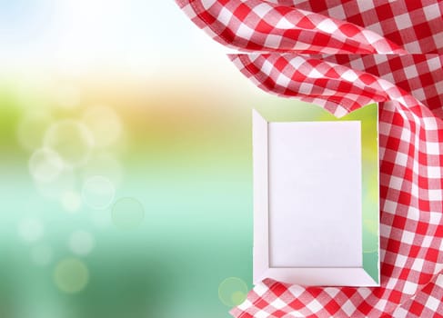 Food Red checkered cloth on green bright bokeh backround. food recipe template concept. Empty menu frame.