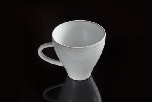 White empty cup on a dark background for a drink