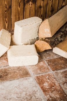 Wood briquette and firewood, close-up