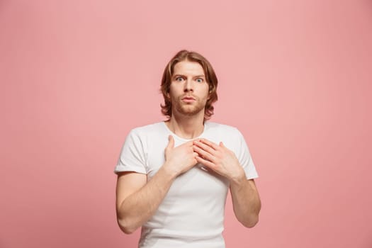 I'm afraid. Fright. Portrait of the scared man. Business man standing isolated on trendy pink studio background. Male half-length portrait. Human emotions, facial expression concept. Front view