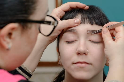 Permanent makeup. Verification of proportions. Cosmetologist applying permanent make up on eyebrows- eyebrow tattoo