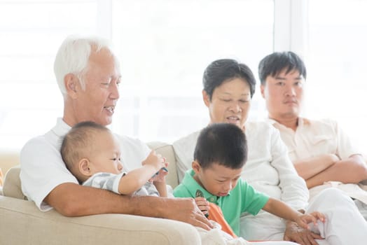 Candid of Asian family at home, multi generations people indoor lifestyle.