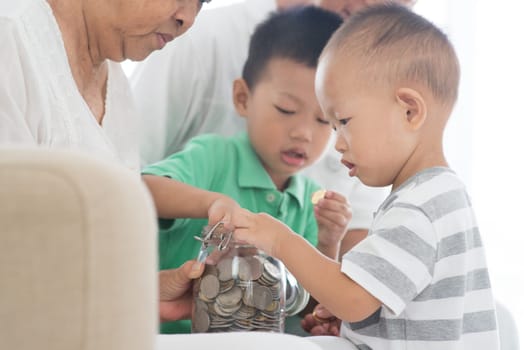 Asian people saving money at home. Family financial planning, investment, insurance, retirement, senior and junior banking concept.