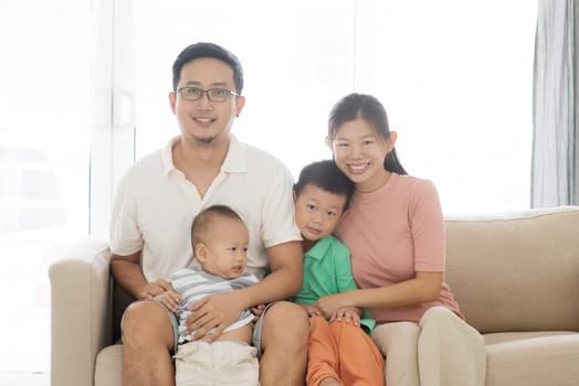 Happy Asian family at home, portrait of parents and children indoor lifestyle.