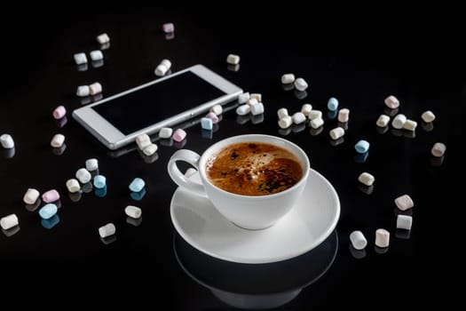 marshmallow in a white cup on a dark background