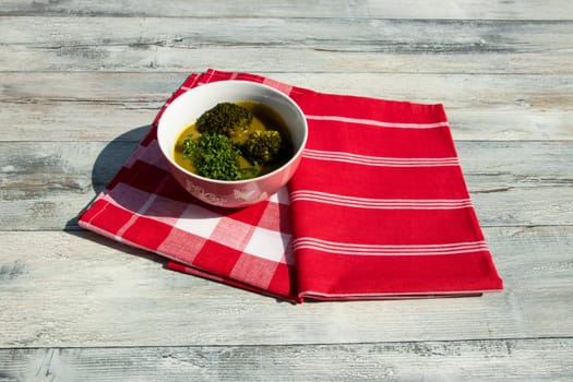 Healthy broccoli soup homemade with parsley. Health concept. Top view outdoor.