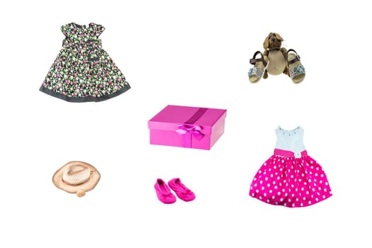Set of little girl clothes for day of the child. Colorful fashion for party or birthday party. Isolated on white. Close up. Decorated with surprise package, funny dog and hat.