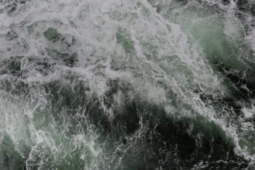 Big water splash seen from above a boat