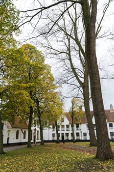 White houses in the court of The Begijnhof. Bruges, Belgium