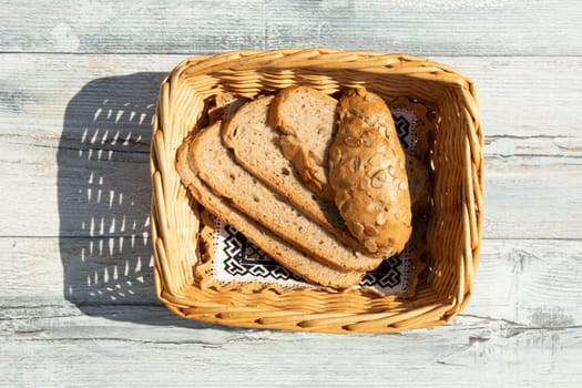 Whole grain bread in basket presented on wooden tabel.  Health concept. top view