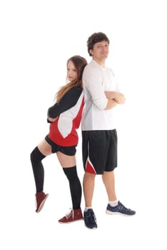 A lovely young couple in there twenties standing in sports attire back.to back with there arms crossed, isolated for white background.
