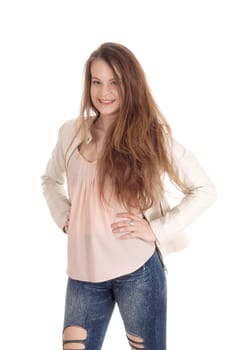 A gorgeous young woman standing with long brunette hair and a.ripped jeans, smiling, isolated for white background.