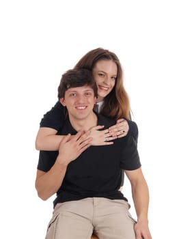 A lovely young couple, he is siting and she is hugging him front the.back, happy and smiling, isolated for white background.
