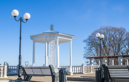 A beautiful romantic gazebo in the park on blue sky background