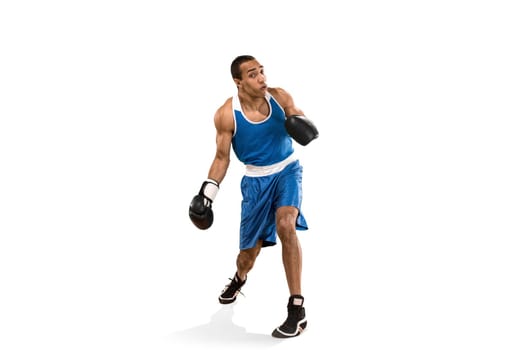 Sporty man during boxing exercises. Photo of boxer on isolated on white background. Strength, attack and motion concept. Fit african american model in movement. Afro muscular athlete in sport uniform
