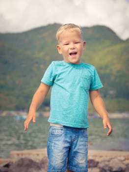 Cute caucasian boy at seaside. Leisure time