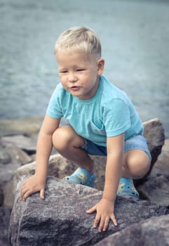 Cute caucasian boy at seaside. Leisure time
