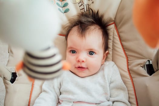 Portrait of a baby girl in her bouncer chair.