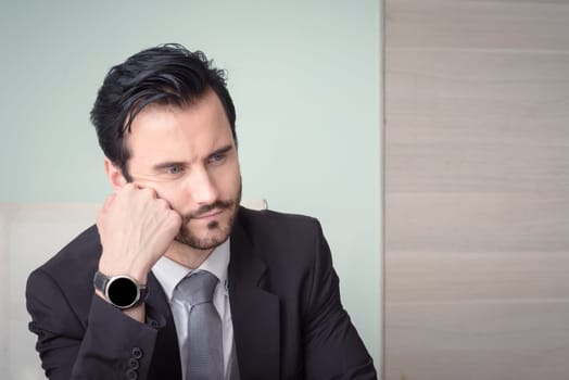 Young depressed stressed frustrated businessman working at office