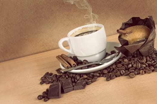 coffee cup with coffee beans, chocolate and muffin