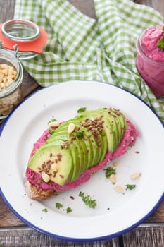 Slice of bread with hummus and fresh avocado
