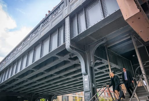 New York, USA, november 2016: people coming out of the High Line in New York through the iron stairs