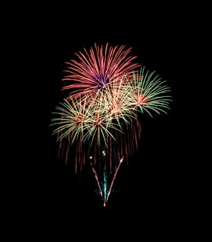 Green and red fireworks isolated on black background