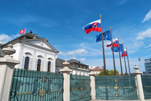 Grassalkovich Palace, Bratislava, Europe. Residence of the president of Slovakia in Bratislava. Grassalkovich Presidential Palace. Slovakian and EU flags. National flags of Slovakia and European Union