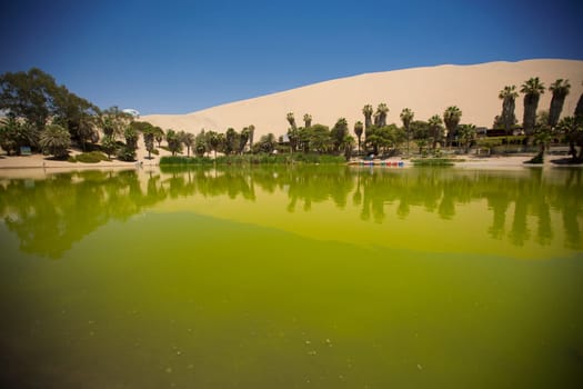 Oasis surrounded by sand dunes near Ica Peru