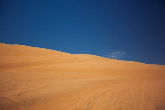Sands dunes in the desert and blue sky.
