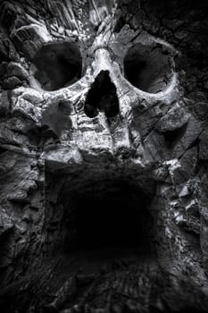 cave in the mountains, a human skull. fantastic picture
