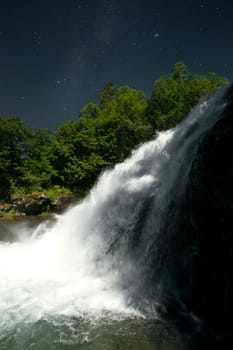 At night, under the light of stars. mountain river. high in the mountains the river flows