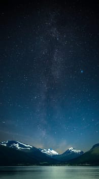 stars shine in the sky over the fjords. Milky Way
