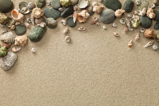 sand,beach background with shells and stones. copy space. top view