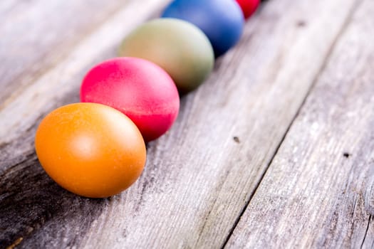 different easter eggs on gray wooden ground
