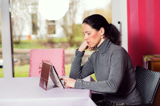 young woman at home using tablet pc
