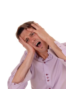 A young man with his hands on his face crying for pain with his head.to the side and mouth open, isolated for white background.