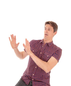 A young man holding his hands up telling everyman do not come.closer to me, I am scared, isolated for white background.