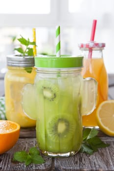 Colorful juices on ice with fresh fruit