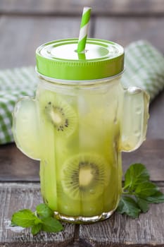 Cactus-shaped mason jar with lemonade with fresh kiwi
