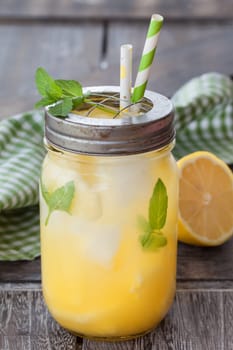 Rustic mason jar with lemonade with fresh pineapple