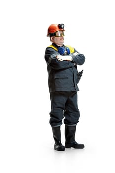 The studio shot of senior bearded serious male miner in professional helmet standing at the camera isolated on a white studio background. Woker and industry concept. Mature caucasian model