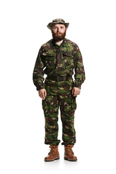 Young army soldier wearing camouflage uniform isolated on white studio background in full-length. Young caucasian model. Military, soldier, army concept. Proffeshional concepts